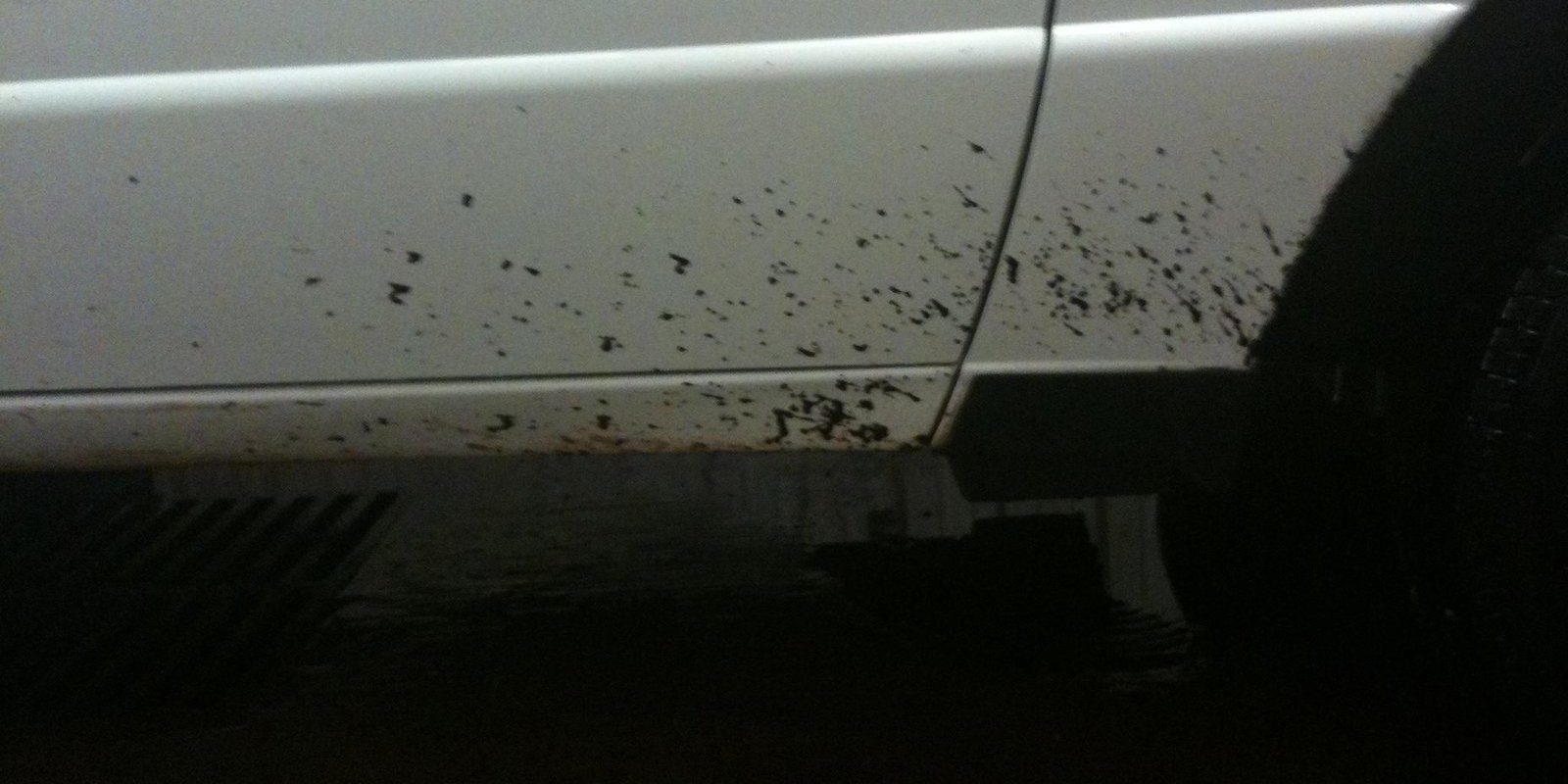 Asphalt spatter across a painted panel.