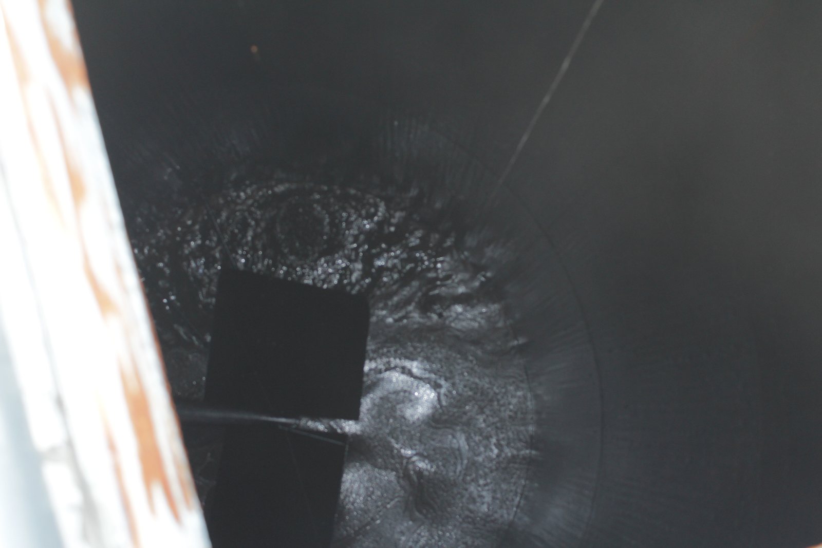 Solidified asphalt inside a storage tank
