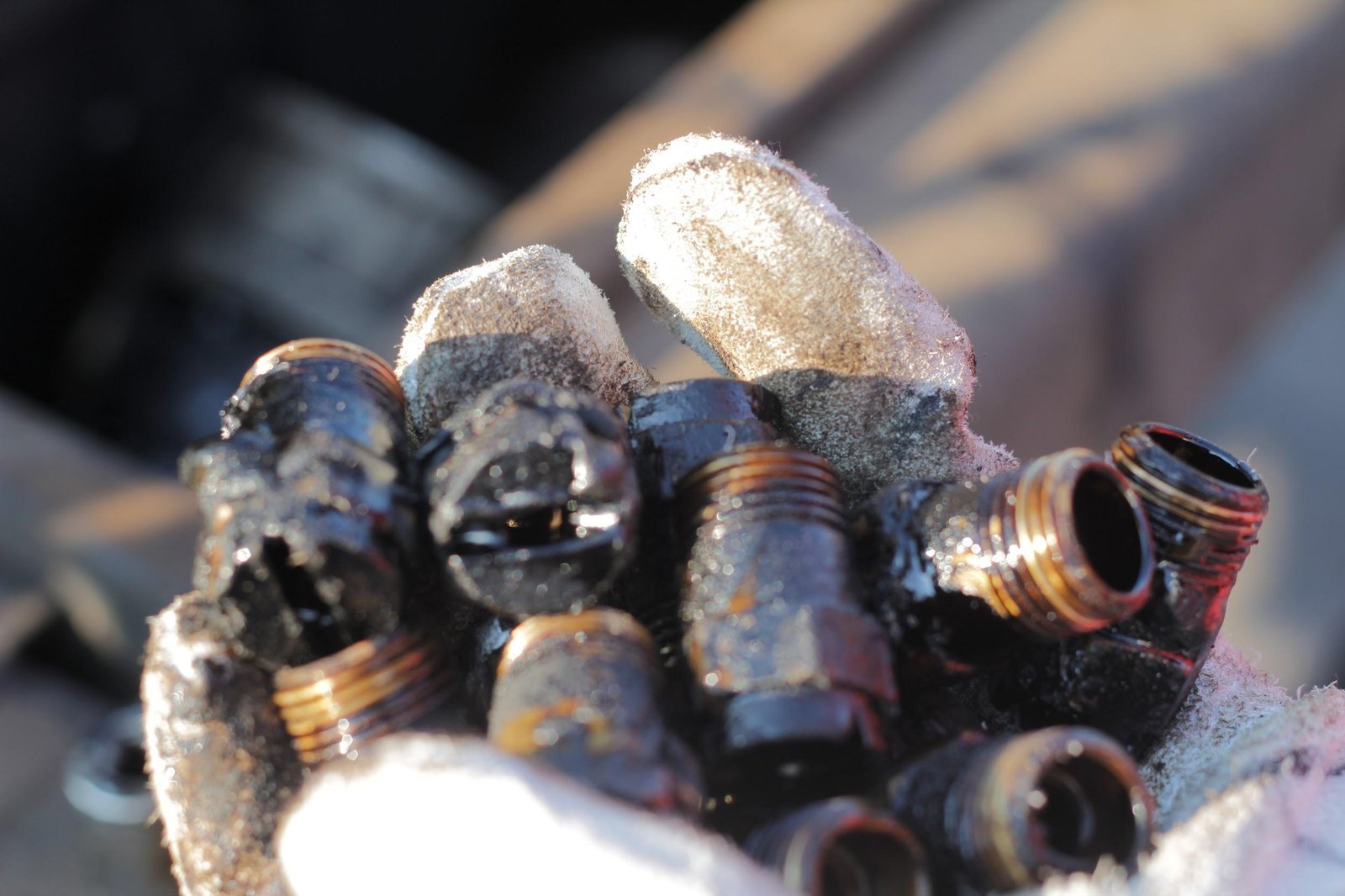 Distributor fittings set solid in asphalt, before cleaning