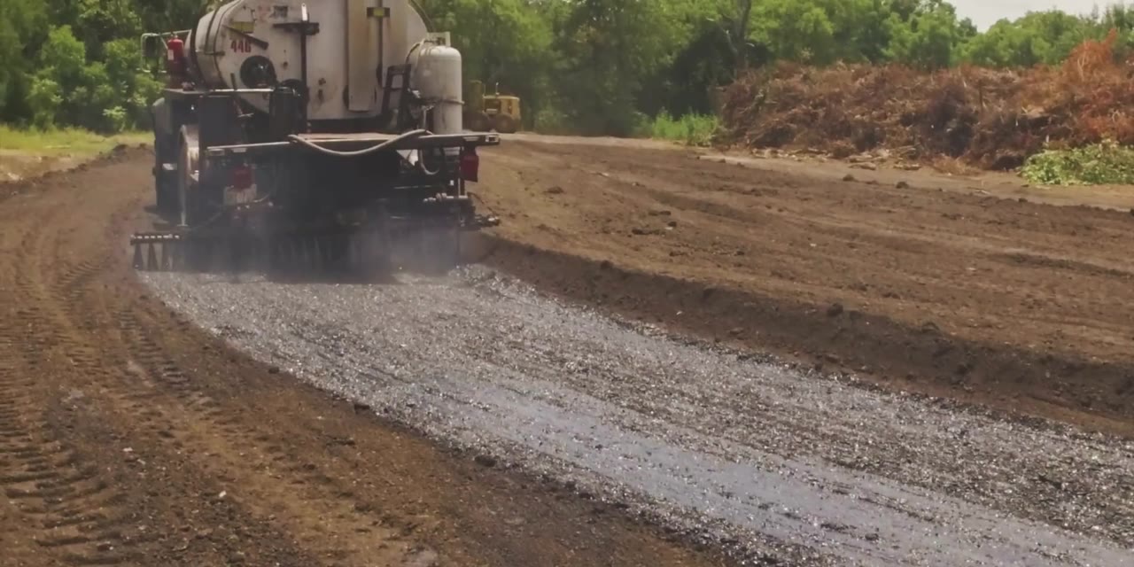 Repurposed material sprayed on the road